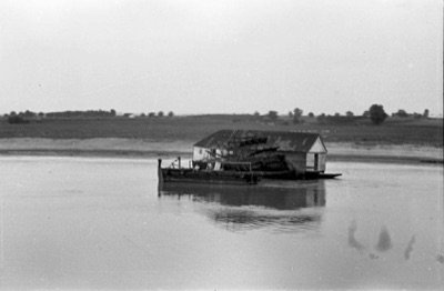 Ship mill anchored in the Danube off a low plain at Novi Sad, about 1937 to 1950